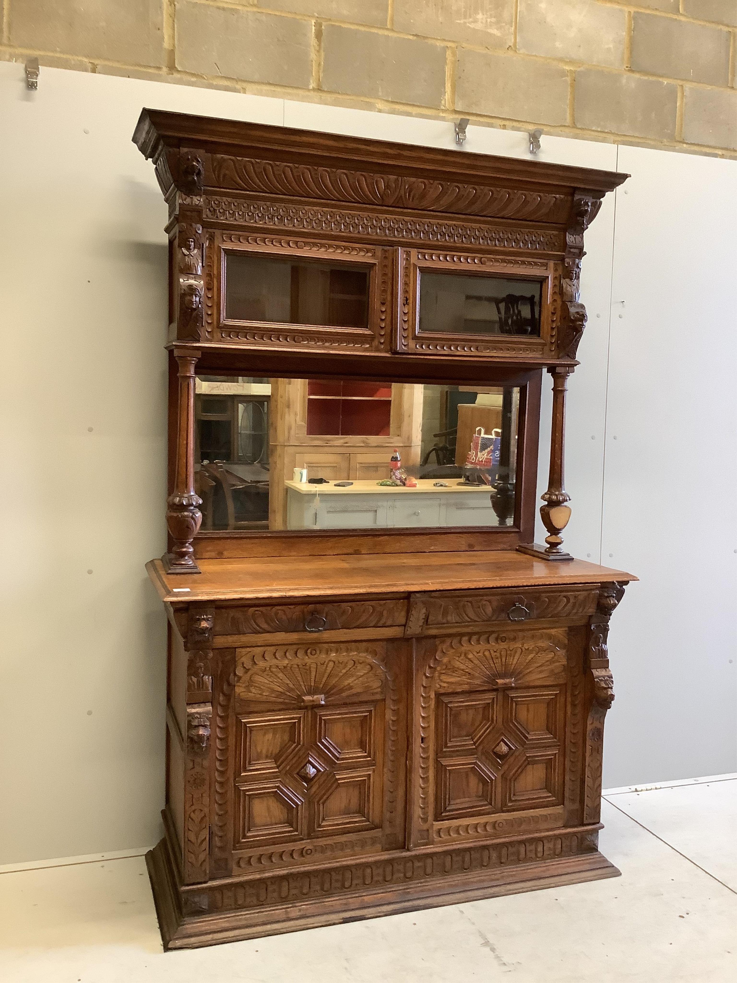 A 19th century Flemish carved oak buffet, width 139cm, depth 54cm, height 214cm. Condition - fair, two pieces of moulding detached but present